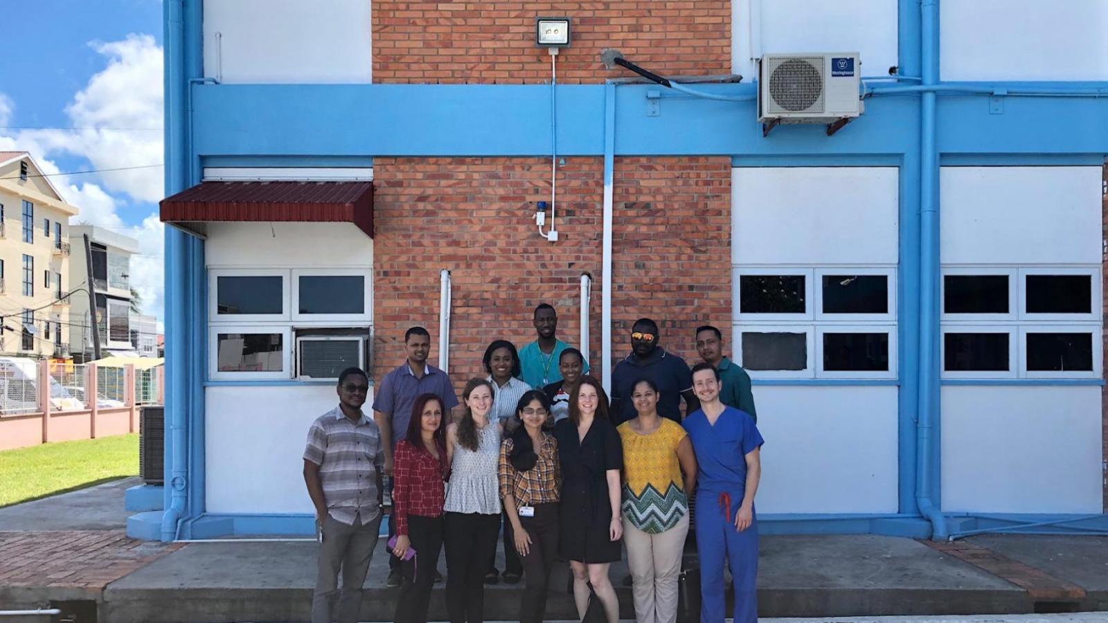 Group of doctors and residents pose outside hospital in Guyana.