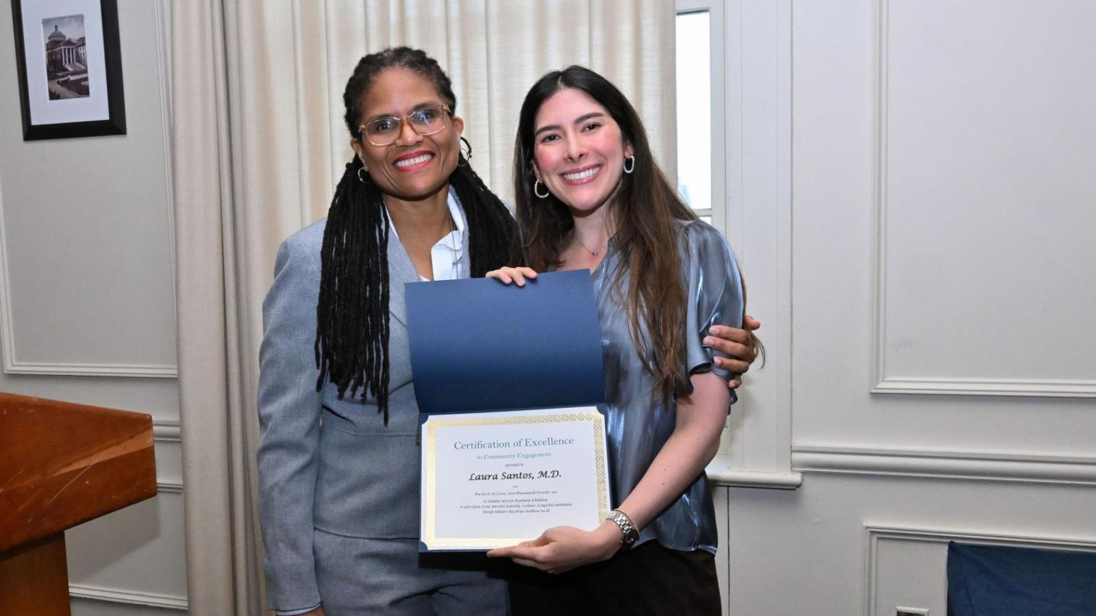 Two women with award certificate