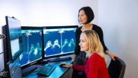 Two female radiologists looking at a screen