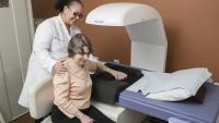 Doctor performing a bone density scan on a patient