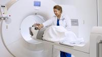 Technician performing a PET scan on a patient