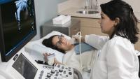 Doctor performing an ultrasound on a patient
