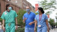 3 resident physicians walk down 168th Street