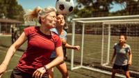 Woman heads a soccer ball