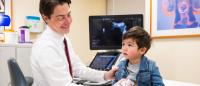 Radiologist doing ultrasound on young child